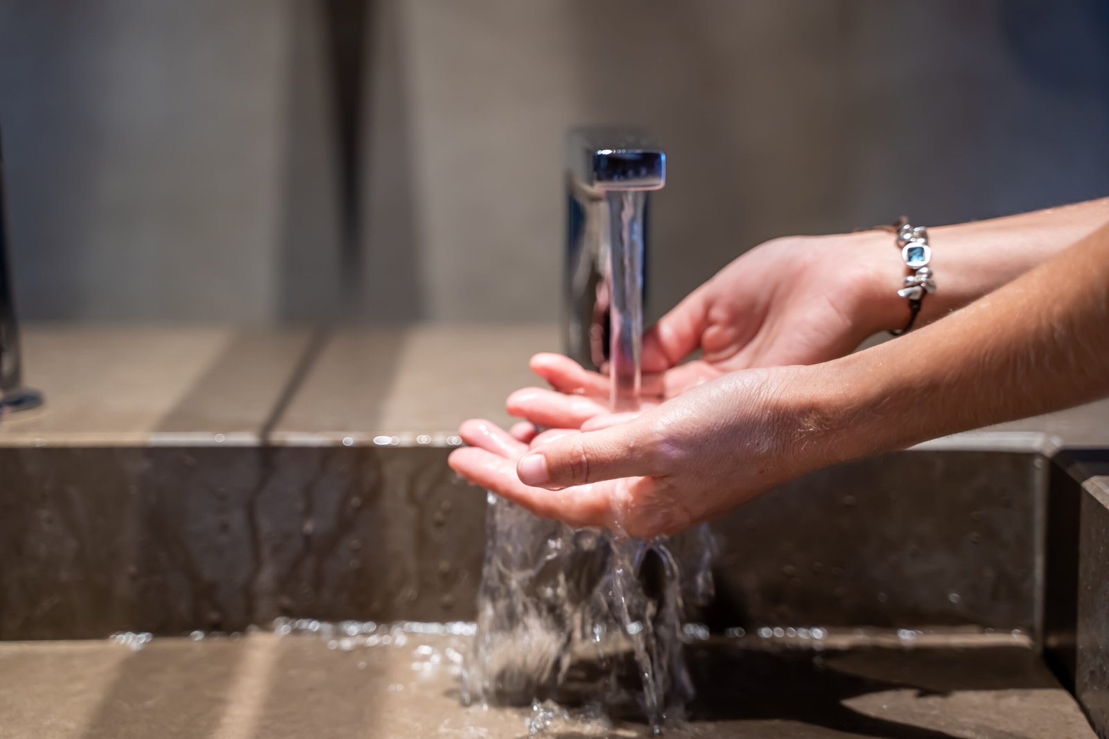 midsection person holding water from faucet scaled